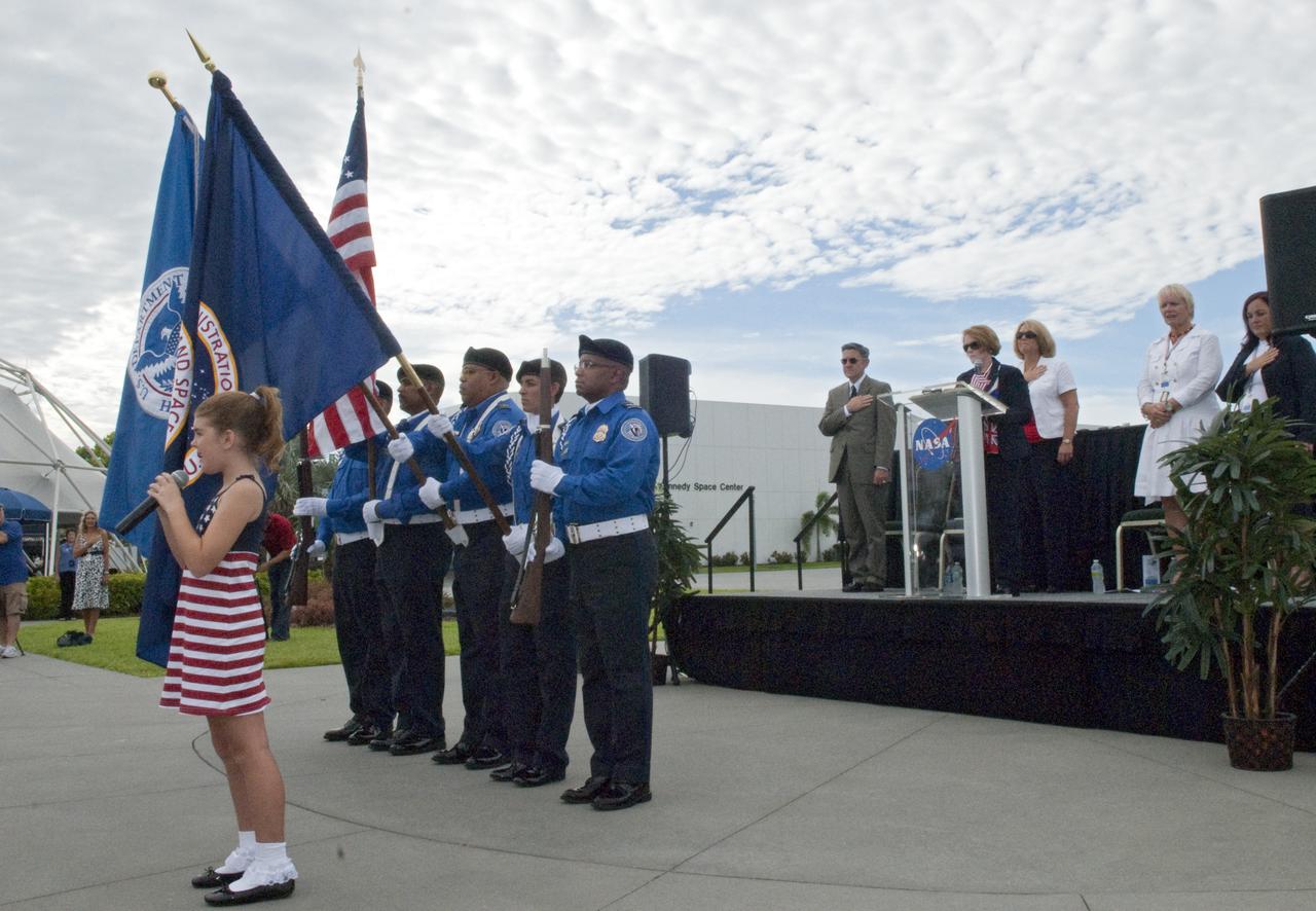 CAPE CANAVERAL, Fla. – At the Kennedy Space Center Visitor Complex in Florida, Searra Weeks, a fifth-grade student at Robert Louis Stevenson Elementary School in Merritt Island, sings the national anthem during a naturalization ceremony. The Transportation and Security Administration Honor Guard posted the American, Homeland Security and NASA flags at the ceremony. U.S. Citizenship and Immigration Services administered the Oath of Allegiance to 110 people, representing 36 countries, in honor of the upcoming Independence Day holiday.    This was the first naturalization ceremony hosted by a NASA facility. An estimated 3,800 candidates will become citizens at 55 special ceremonies, including the one at Kennedy, held across the country and around the world July 1-6. Photo Credit: NASA_Jim Grossmann