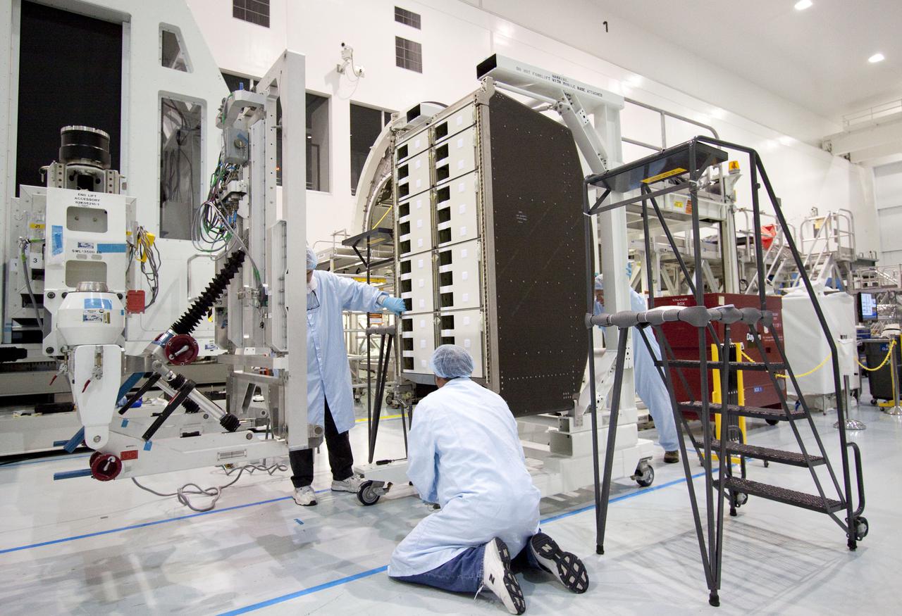 CAPE CANAVERAL, Fla. – In the Space Station Processing Facility at NASA's Kennedy Space Center in Florida, technicians prepare to install a resupply rack into the Permanent Multipurpose Module, or PMM.      The Leonardo multi-purpose logistics module, or MPLM, is being modified to become the PMM that will carry supplies and critical spare parts to the International Space Station aboard space shuttle Discovery’s STS-133 mission. Discovery, targeted to launch Nov. 1, will leave the module behind so it can be used for microgravity experiments in fluid physics, materials science, biology and biotechnology. Photo credit: NASA_Jack Pfaller