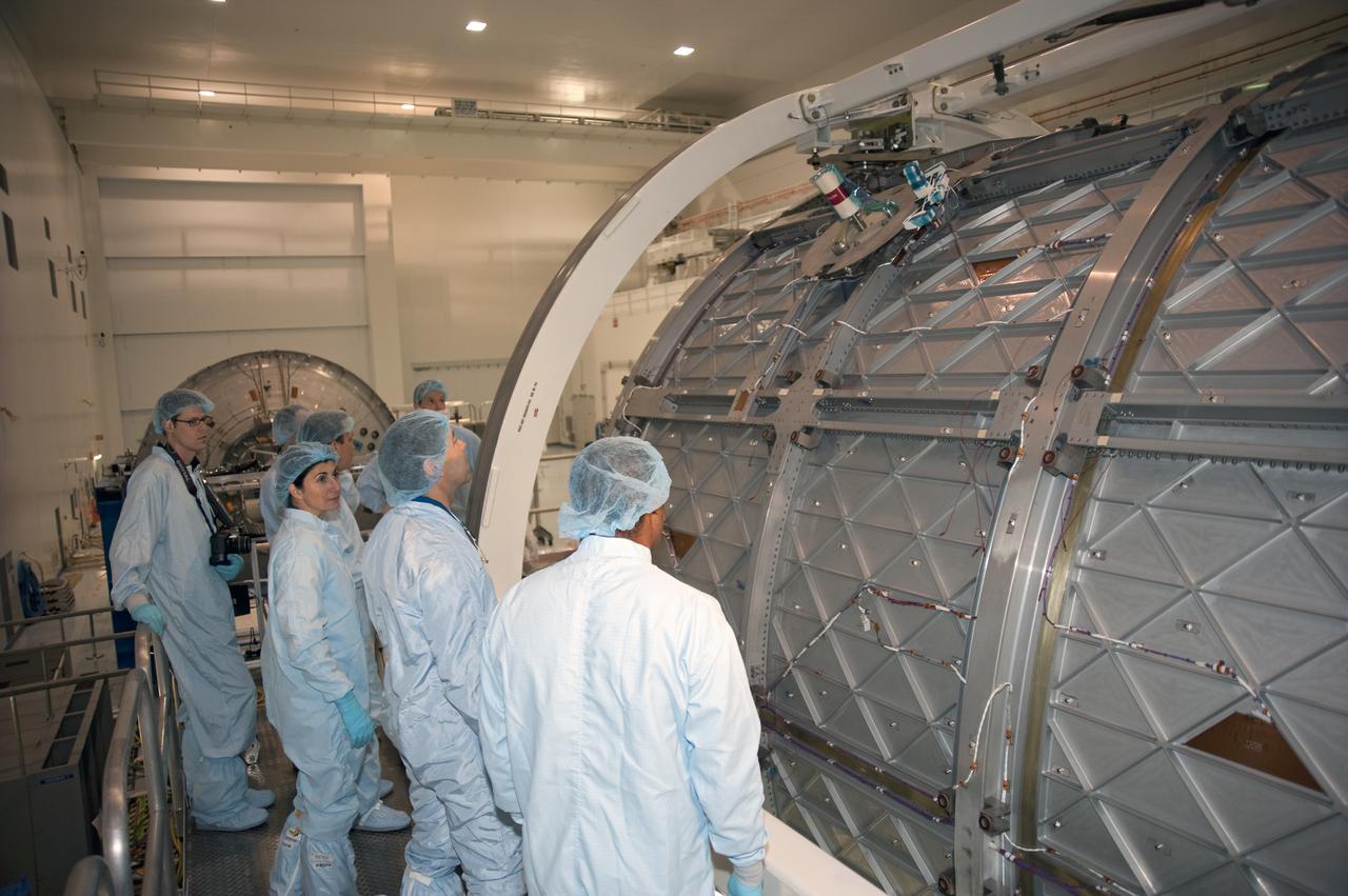 CAPE CANAVERAL, Fla. -- In the Space Station Processing Facility at NASA's Kennedy Space Center in Florida, the STS-133 crew members examine the exterior of the Permanent Multipurpose Module, or PMM. Pictured are Mission Specialists Nicole Stott and Michael Barratt. The PMM will be used to carry supplies and critical spare parts to the station and will be left behind so it can be used for microgravity experiments in fluid physics, materials science, biology and biotechnology.     The astronauts are at Kennedy for the Crew Equipment Interface Test, or CEIT, which provides the crew with hands-on training and observation of shuttle and flight hardware for their mission to the International Space Station. Launch of the STS-133 mission on space shuttle Discovery is targeted for Nov. 1 at 4:33 p.m. EDT. Photo credit: NASA_Kim Shiflett