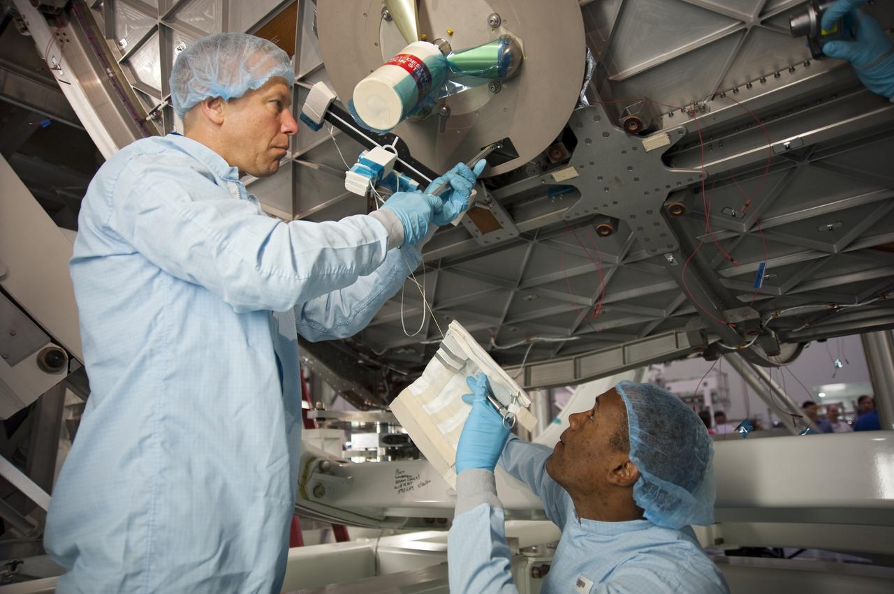 CAPE CANAVERAL, Fla. -- In the Space Station Processing Facility at NASA's Kennedy Space Center in Florida, STS-133 Mission Specialist Alvin Drew (right) assists Mission Specialist Tim Kopra during a hands-on exercise with tools they will use on the mission. The astronauts are at Kennedy for the Crew Equipment Interface Test, or CEIT, which provides the crew with hands-on training and observation of shuttle and flight hardware for their mission to the International Space Station. Launch of the STS-133 mission on space shuttle Discovery is targeted for Nov. 1 at 4:33 p.m. EDT. Photo credit: NASA_Kim Shiflett