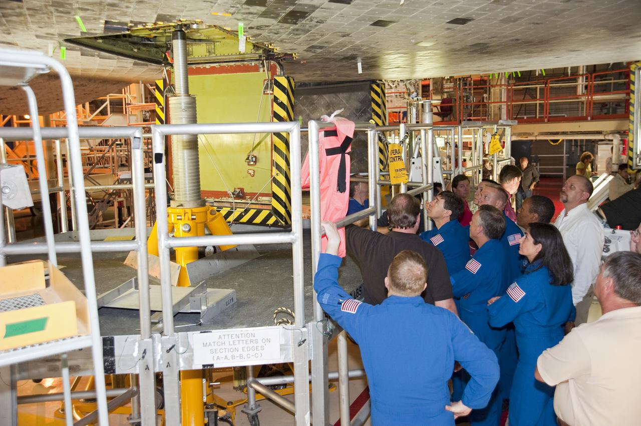 CAPE CANAVERAL, Fla. -- In Orbiter Processing Facility-3 at NASA's Kennedy Space Center in Florida, the STS-133 crew members look up into the shuttle's wheel well as a technician describes the landing gear.    The astronauts are at Kennedy for the Crew Equipment Interface Test, or CEIT, which provides the crew with hands-on training and observation of shuttle and flight hardware for their mission to the International Space Station. Launch of the STS-133 mission on space shuttle Discovery is targeted for Nov. 1 at 4:33 p.m. EDT. Photo credit: NASA_Kim Shiflett
