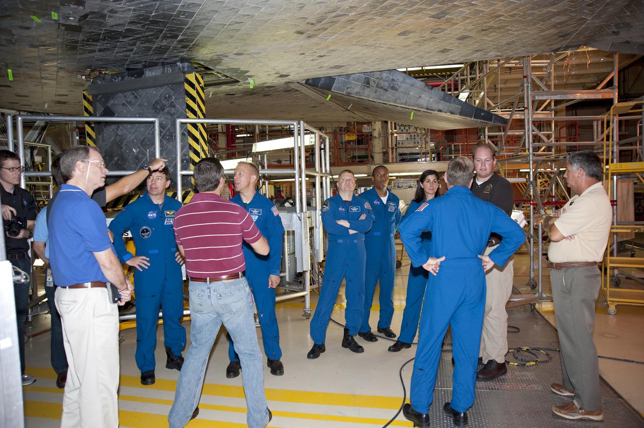 CAPE CANAVERAL, Fla. -- In Orbiter Processing Facility-3 at NASA's Kennedy Space Center in Florida, the STS-133 crew members inspect thermal protection system underneath the shuttle.    The astronauts are at Kennedy for the Crew Equipment Interface Test, or CEIT, which provides the crew with hands-on training and observation of shuttle and flight hardware for their mission to the International Space Station. Launch of the STS-133 mission on space shuttle Discovery is targeted for Nov. 1 at 4:33 p.m. EDT. Photo credit: NASA_Kim Shiflett