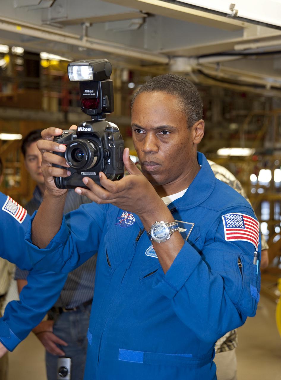CAPE CANAVERAL, Fla. -- In Orbiter Processing Facility-3 at NASA's Kennedy Space Center in Florida, STS-133 Mission Specialist Alvin Drew looks through the viewfinder of a camera that he will  use while in space.    The astronauts are at Kennedy for the Crew Equipment Interface Test, or CEIT, which provides the crew with hands-on training and observation of shuttle and flight hardware for their mission to the International Space Station. Launch of the STS-133 mission on space shuttle Discovery is targeted for Nov. 1 at 4:33 p.m. EDT. Photo credit: NASA_Kim Shiflett