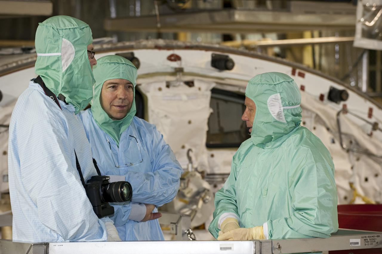 CAPE CANAVERAL, Fla. --  In Orbiter Processing Facility-3 at NASA's Kennedy Space Center in Florida, a technician speaks with STS-133 Mission Specialist Michael Barratt (left) and Commander Steve Lindsey inside the shuttle's payload bay.    The astronauts are at Kennedy for the Crew Equipment Interface Test, or CEIT, which provides the crew with hands-on training and observation of shuttle and flight hardware for their mission to the International Space Station. Launch of the STS-133 mission on space shuttle Discovery is targeted for Nov. 1 at 4:33 p.m. EDT. Photo credit: NASA_Kim Shiflett