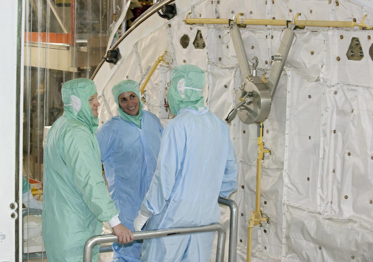CAPE CANAVERAL, Fla. -- In Orbiter Processing Facility-3 at NASA's Kennedy Space Center in Florida, STS-133 Pilot Eric Boe (left) and Mission Specialist Nicole Stott enjoy the moment as a technician describes an element of the shuttle's payload bay.    The astronauts are at Kennedy for the Crew Equipment Interface Test, or CEIT, which provides the crew with hands-on training and observation of shuttle and flight hardware for their mission to the International Space Station. Launch of the STS-133 mission on space shuttle Discovery is targeted for Nov. 1 at 4:33 p.m. EDT. Photo credit: NASA_Kim Shiflett