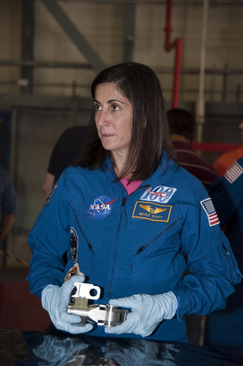 CAPE CANAVERAL, Fla. -- In Orbiter Processing Facility-3 at NASA's Kennedy Space Center in Florida, STS-133 Mission Specialist Nicole Stott is given the opportunity to get a close look of the equipment that will be used on their  mission.    The astronauts are at Kennedy for the Crew Equipment Interface Test, or CEIT, which provides the crew with hands-on training and observation of shuttle and flight hardware for their mission to the International Space Station. Launch of the STS-133 mission on space shuttle Discovery is targeted for Nov. 1 at 4:33 p.m. EDT. Photo credit: NASA_Kim Shiflett