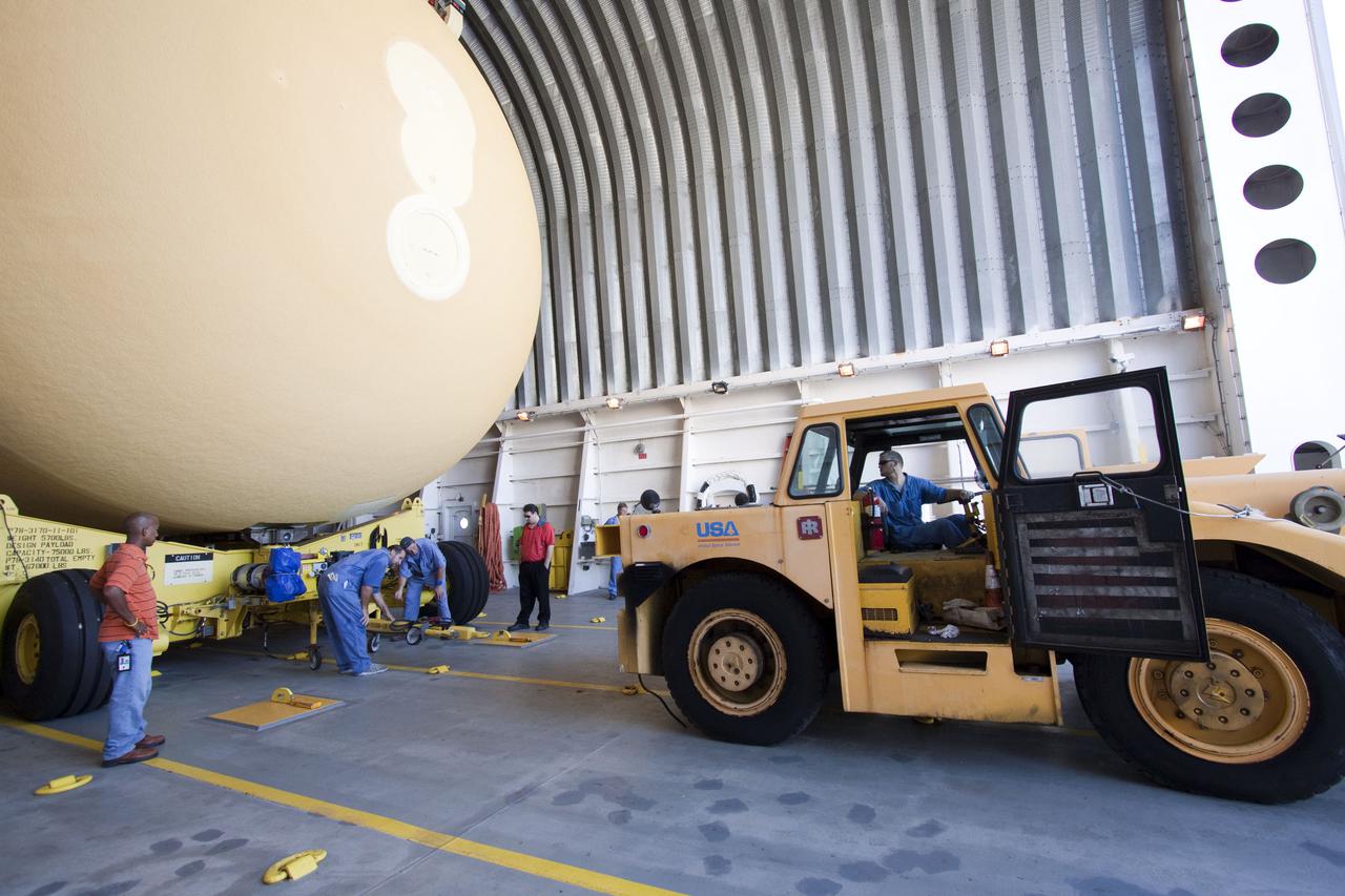 CAPE CANAVERAL, Fla. -- At NASA's Kennedy Space Center in Florida, workers prepare External Tank-138 for offload from the Pegasus barge docked in the turn basin near the Vehicle Assembly Building. The external fuel tank arrived in Florida on July 13, from NASA's Michoud Assembly Facility near New Orleans. ET-138, the last newly manufactured tank, was originally designated to fly on Endeavour's STS-134 mission to the International Space Station, but later reassigned to fly on space shuttle Atlantis' final mission, STS-135. For information, visit www.nasa.gov_shuttle. Photo credit: NASA_Jack Pfaller