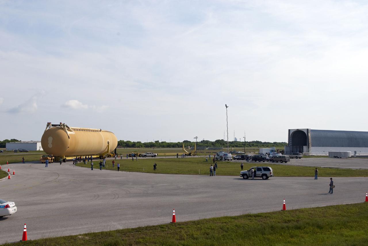 CAPE CANAVERAL, Fla. -- At NASA's Kennedy Space Center in Florida, workers accompany the newly offloaded External Tank-138 from the Pegasus barge docked in the turn basin. The external fuel tank arrived in Florida on July 13, from NASA's Michoud Assembly Facility near New Orleans. ET-138, the last newly manufactured tank, was originally designated to fly on Endeavour's STS-134 mission to the International Space Station, but later reassigned to fly on space shuttle Atlantis' final mission, STS-135. For information, visit www.nasa.gov_shuttle. Photo credit: NASA_Jim Grossmann