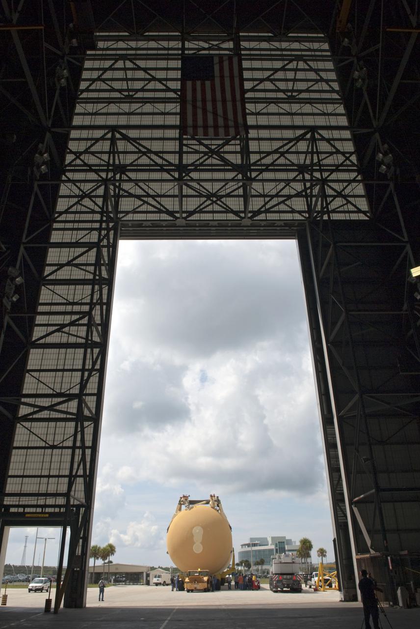 CAPE CANAVERAL, Fla. -- Viewed from inside the Vehicle Assembly Building at NASA's Kennedy Space Center in Florida, External Tank-138 is being towed toward the massive door of the building. The external fuel tank arrived in Florida on July 13, from NASA's Michoud Assembly Facility near New Orleans. ET-138, the last newly manufactured tank, was originally designated to fly on Endeavour's STS-134 mission to the International Space Station, but later reassigned to fly on space shuttle Atlantis' final mission, STS-135. For information, visit www.nasa.gov_shuttle. Photo credit: NASA_Jim Grossmann