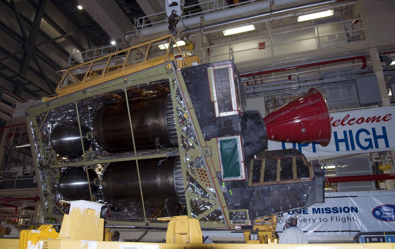 CAPE CANAVERAL, Fla. -- In Orbiter Processing Facility-3 at NASA's Kennedy Space Center in Florida, the right-hand orbital maneuvering system, or OMS, pod is being lifted by an overhead crane for installation on space shuttle Discovery.       Discovery and its crew will deliver the Permanent Multipurpose Module, or PMM, which will carry supplies and critical spare parts on the STS-133 mission to the International Space Station. The module will be left behind so it can be used for microgravity experiments in fluid physics, materials science, biology and biotechnology. For more information go to www.nasa.gov_shuttle.  Photo credit: NASA_Ben Smegelsky