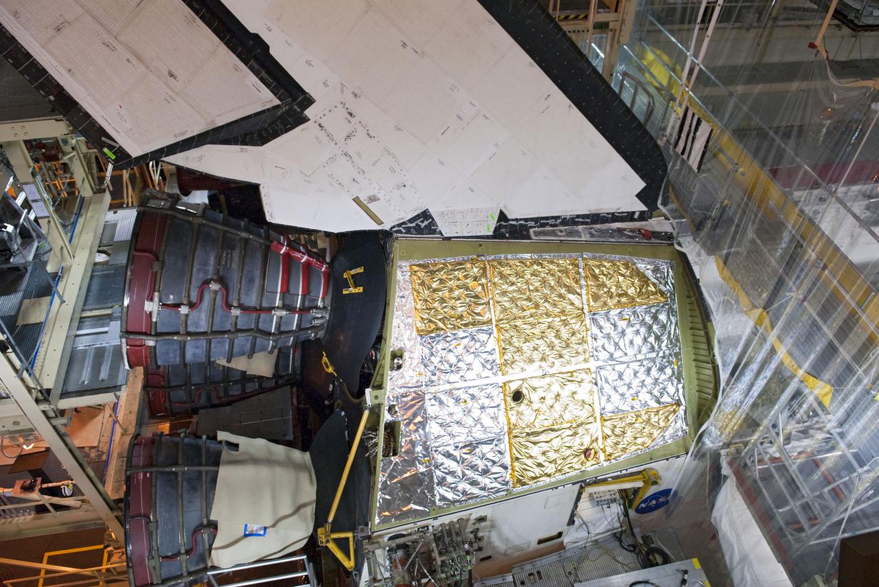 CAPE CANAVERAL, Fla. -- In Orbiter Processing Facility-3 at NASA's Kennedy Space Center in Florida, the aft section on space shuttle Discovery is set to accept the installation of the right-hand orbital maneuvering system, or OMS, pod.     Discovery and its crew will deliver the Permanent Multipurpose Module, or PMM, which will carry supplies and critical spare parts on the STS-133 mission to the International Space Station. The module will be left behind so it can be used for microgravity experiments in fluid physics, materials science, biology and biotechnology. For more information go to www.nasa.gov_shuttle.  Photo credit: NASA_Ben Smegelsky