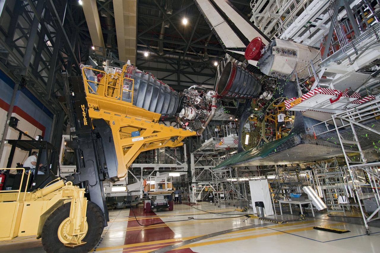 CAPE CANAVERAL, Fla. -- In Orbiter Processing Facility-1 at NASA's Kennedy Space Center in Florida, the Hyster engine lift moves main engine no. 3 away from space shuttle Atlantis.       Inspection and maintenance of each main engine is standard procedure following a shuttle mission. Some of the engines maintained and stored in the engine shop could be used for Atlantis, on what currently is planned as the 'launch on need,' or potential rescue mission for Endeavour's STS-134 mission, targeted for launch Feb. 26, 2011. For information, visit www.nasa.gov_shuttle. Photo credit: NASA_Jack Pfaller