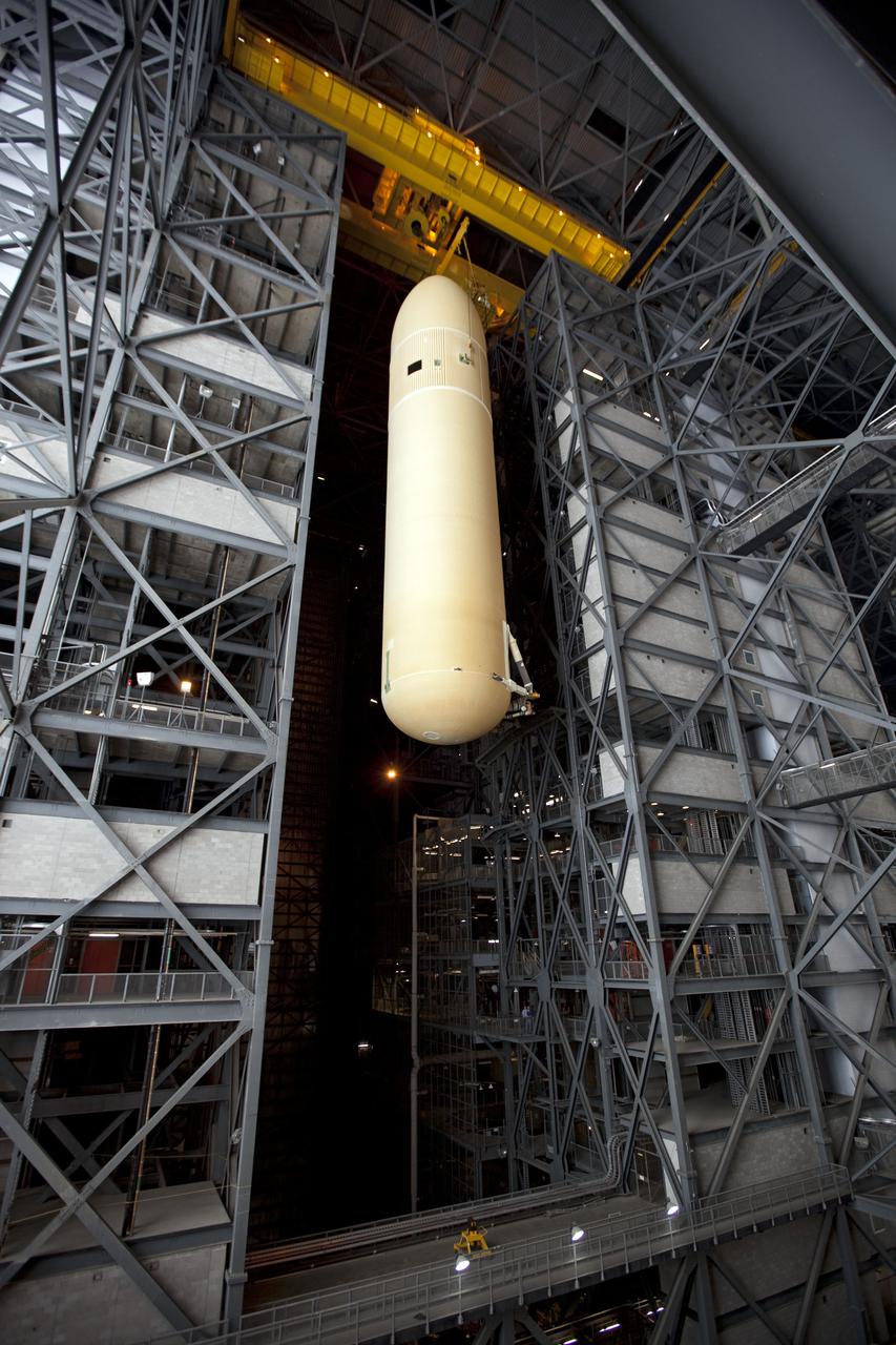 CAPE CANAVERAL, Fla. -- External Tank-138 is lifted high above the transfer aisle in the Vehicle Assembly Building at NASA's Kennedy Space Center in Florida, prior to its move to a test cell where it will be checked before launch. ET-138, the last newly manufactured tank, was originally designated to fly on Endeavour's STS-134 mission to the International Space Station, but later reassigned to fly on space shuttle Atlantis' final mission, STS-135. For information, visit www.nasa.gov_shuttle. Photo credit: NASA_Dimitri Gerondidakis