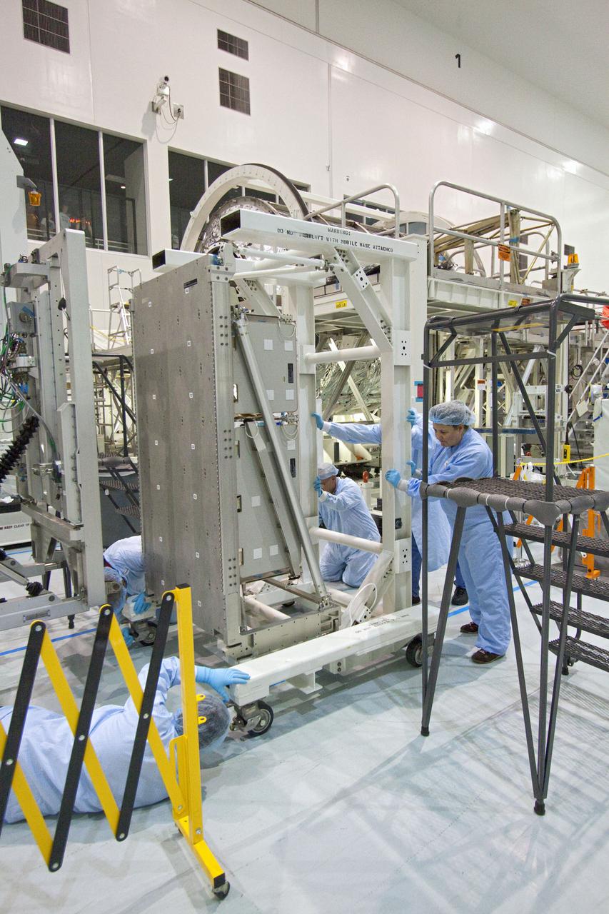 CAPE CANAVERAL, Fla. -- In the Space Station Processing Facility at NASA's Kennedy Space Center in Florida, workers prepare a resupply stowage platform prior to installation of  cargo headed to the International Space Station. The stowage platforms will then be moved into the Permanent Multipurpose Module, or PMM.     The PMM will be used to carry supplies and critical spare parts to the station. The module will be left behind so it can be used for microgravity experiments in fluid physics, materials science, biology and biotechnology. Space shuttle Discovery will deliver its payload to the station on the STS-133 mission. Launch is targeted for Nov. 1 at 4:33 p.m. EDT. Photo credit: NASA_Jack Pfaller