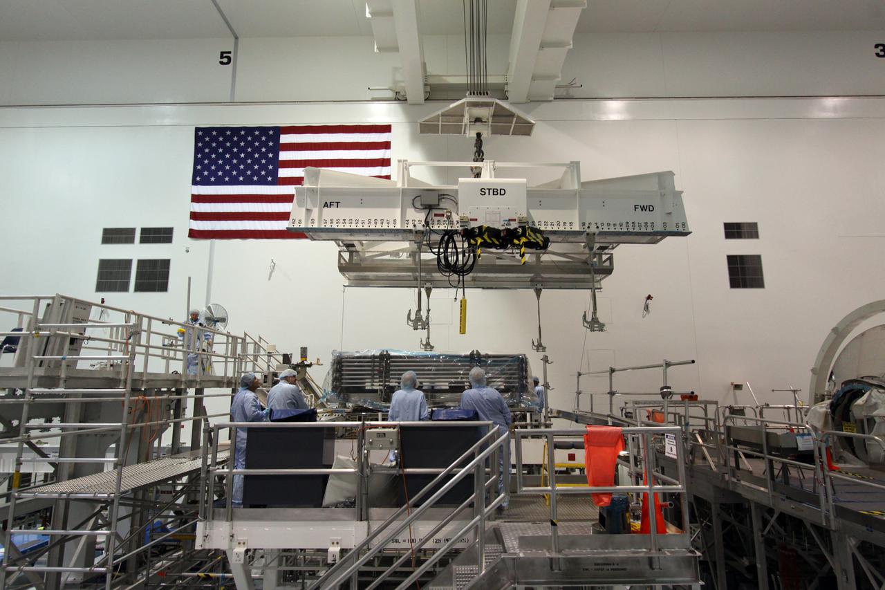 CAPE CANAVERAL, Fla. -- In the Space Station Processing Facility at NASA's Kennedy Space Center in Florida, technicians hoist the Express Logistics Carrier-4, or ELC-4, for the deck-to-keel mate. The deck is about 14 by 16 feet and spans the width of a space shuttle’s payload bay. It is capable of providing astronauts aboard the International Space Station with a platform and infrastructure to deploy experiments in the vacuum of space without requiring a separate dedicated Earth-orbiting satellite. Space shuttle Discovery and its STS-133 crew will deliver the carrier along with critical spare parts to the station later this year. Photo credit: NASA_Jack Pfaller