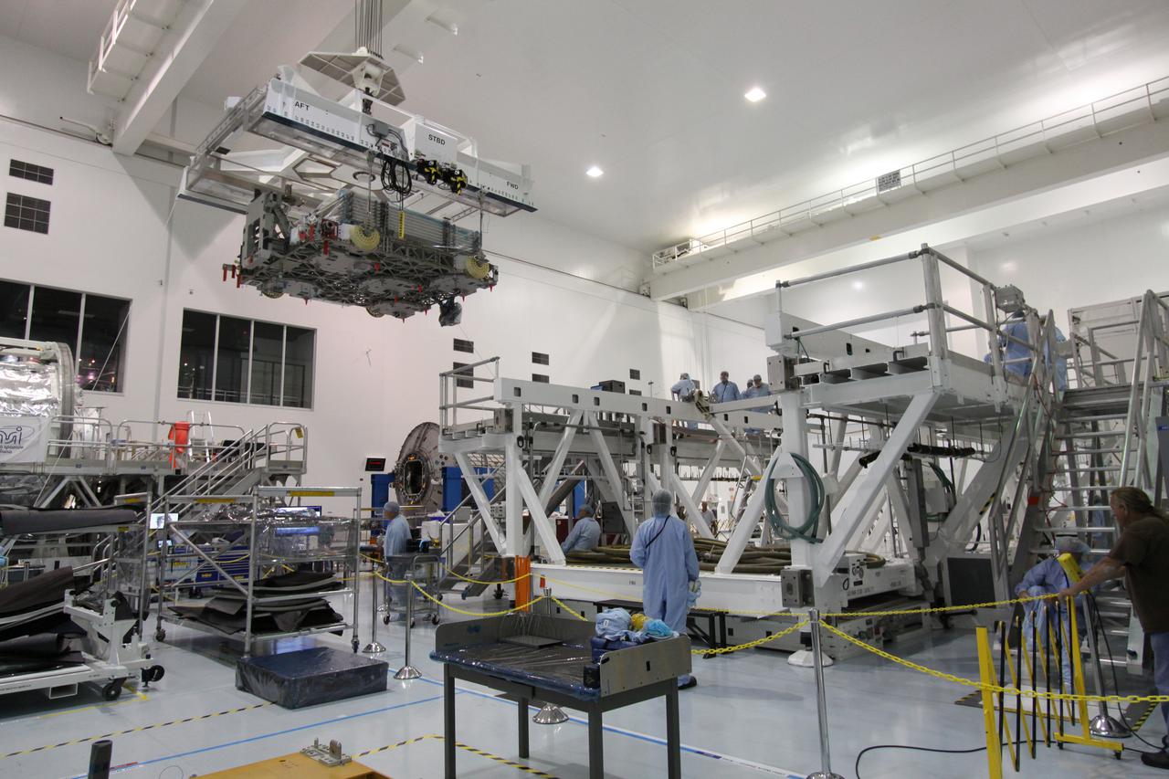 CAPE CANAVERAL, Fla. -- In the Space Station Processing Facility at NASA's Kennedy Space Center in Florida, technicians perform the Express Logistics Carrier-4, or ELC-4, deck-to-keel mate. The deck is about 14 by 16 feet and spans the width of a space shuttle’s payload bay. It is capable of providing astronauts aboard the International Space Station with a platform and infrastructure to deploy experiments in the vacuum of space without requiring a separate dedicated Earth-orbiting satellite. Space shuttle Discovery and its STS-133 crew will deliver the carrier along with critical spare parts to the station later this year. Photo credit: NASA_Jack Pfaller