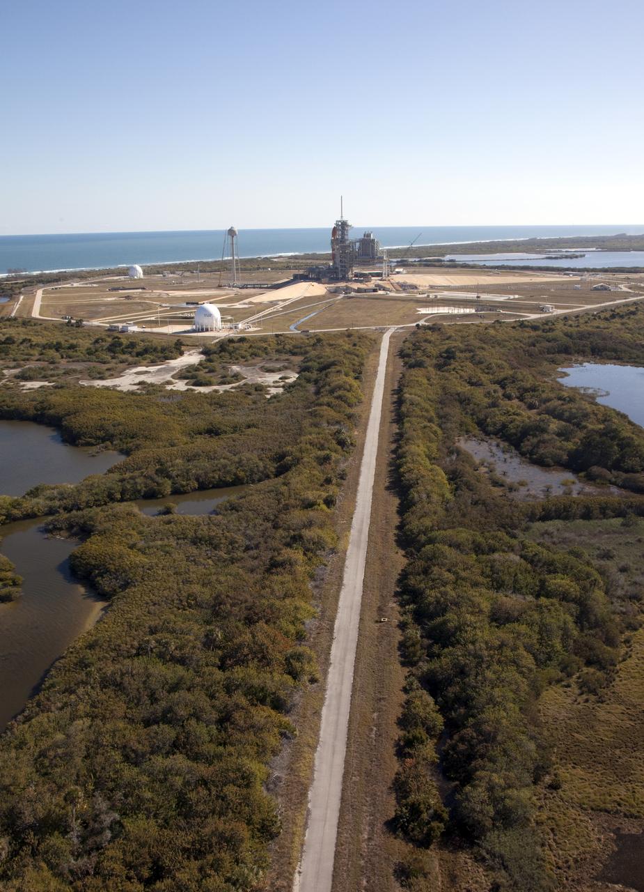 Aerials - STS-133 Discovery on Pad 39A, LEED Bldg., VAB