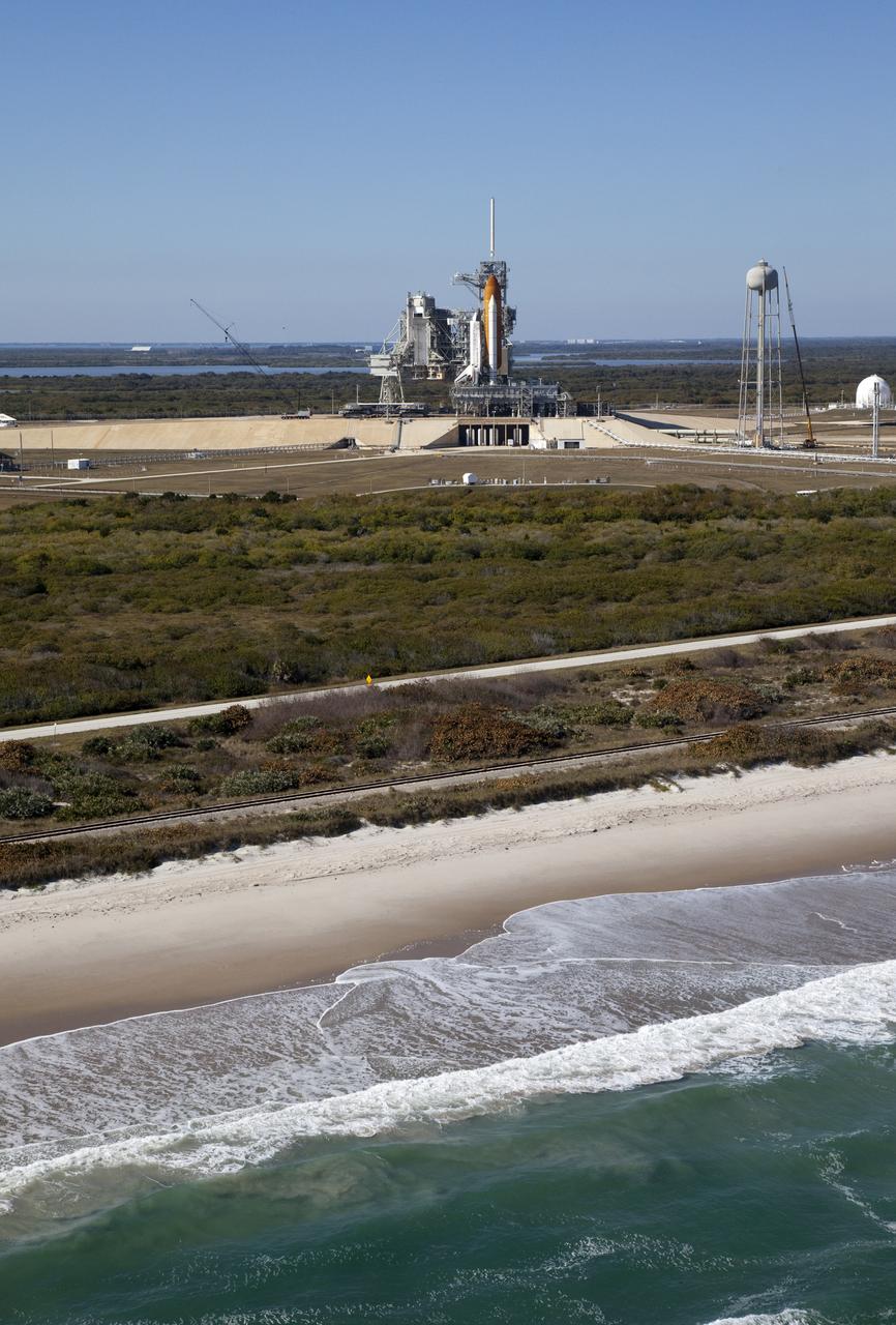Aerials - STS-133 Discovery on Pad 39A, LEED Bldg., VAB