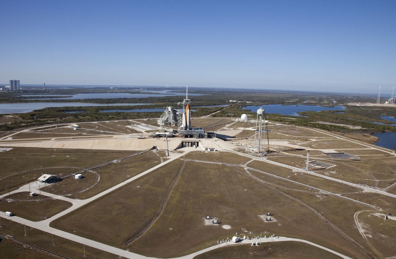 Aerials - STS-133 Discovery on Pad 39A, LEED Bldg., VAB