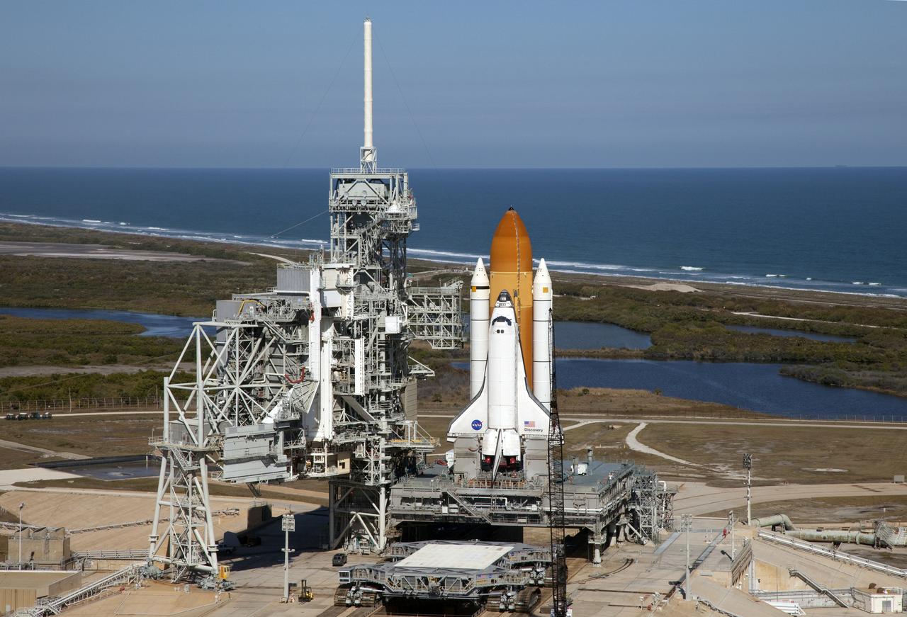 Aerials - STS-133 Discovery on Pad 39A, LEED Bldg., VAB