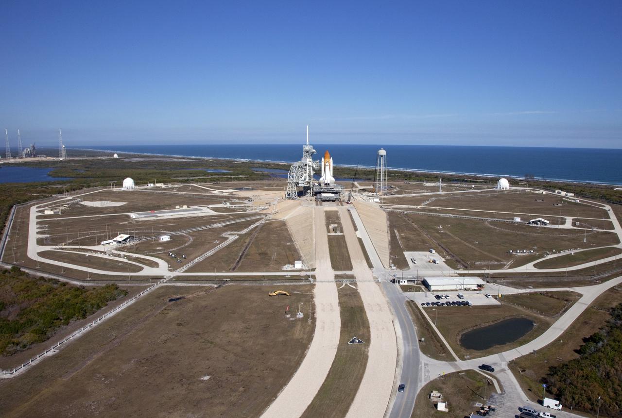 Aerials - STS-133 Discovery on Pad 39A, LEED Bldg., VAB