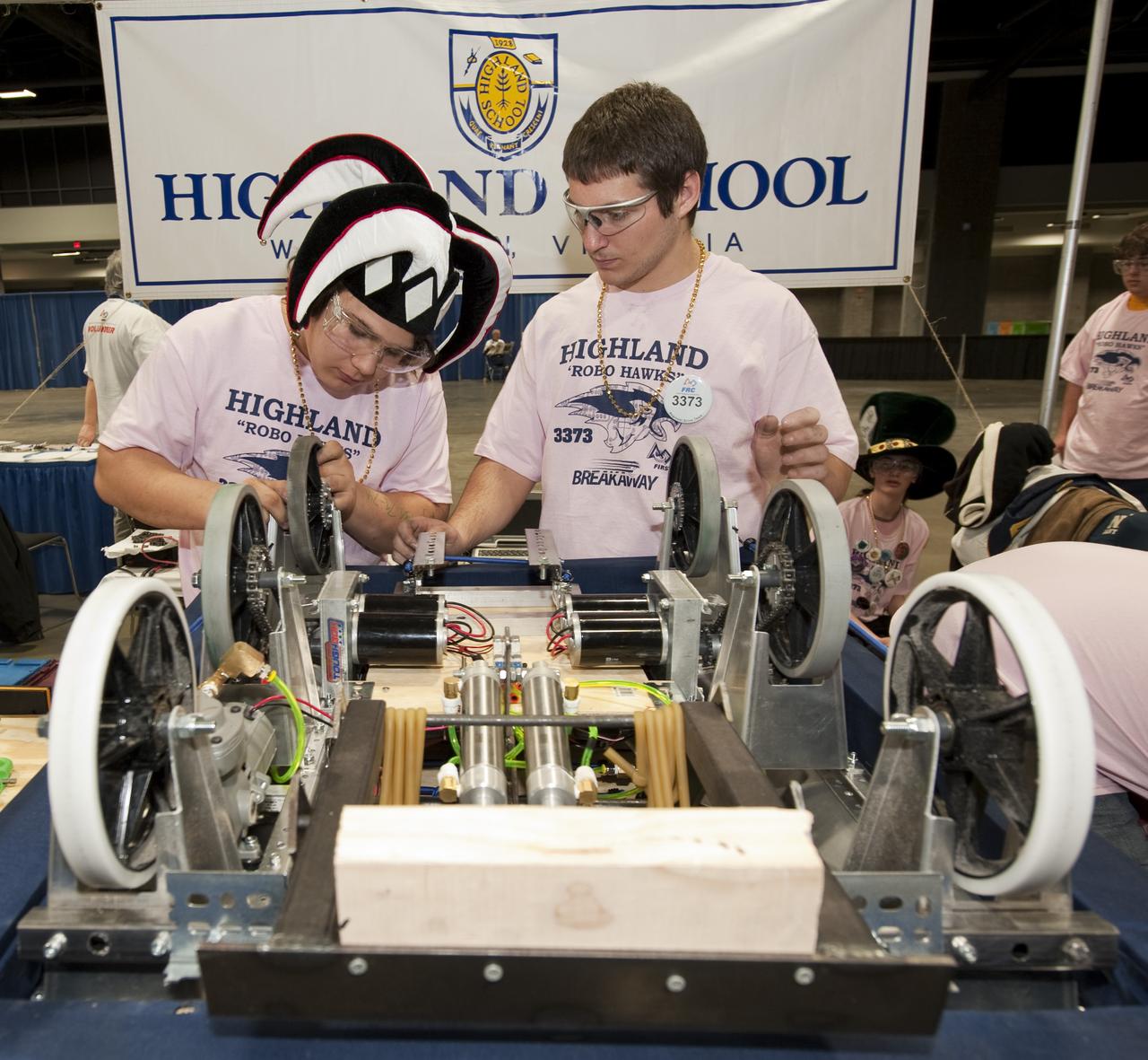 Students from the Highland School in Warrenton, Va. work on their robot in the "Pit Area" as they prepare to compete in the First Robotics Competition, Friday, March 5, 2010, in Washington. The student competition is called "For Inspiration and Recognition of Science and Technology," or FIRST. The program was founded in 1989 by inventor Dean Kamen to inspire an appreciation of science and technology in young people, their schools and communities. Photo Credit: (NASA/Paul E. Alers) Photo Credit: (NASA/Paul E. Alers)