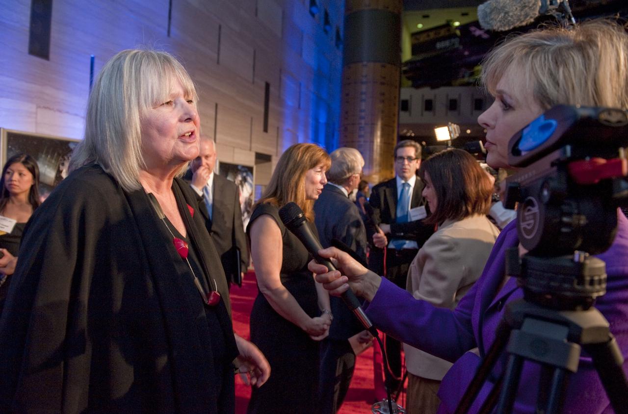 Producer/Director Toni Myers,  left, speaks to a reporter as Deputy Administrator for NASA Lori Garver, second from left, is interviewed by another on the red carpet prior to the World Premiere of "Hubble 3D", screened at the Smithsonian's Air and Space Museum Tuesday evening, March 9, 2010, in Washington. Photo Credit: (NASA/Paul E. Alers)