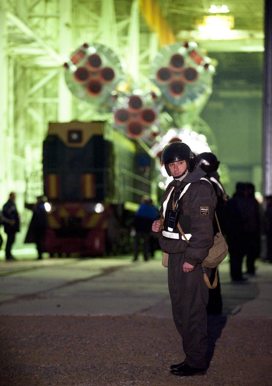 A Russian security officer stands guard as the Soyuz TMA-18 spacecraft is rolled out by train to the launch pad at the Baikonur Cosmodrome, Kazakhstan, Wednesday, March, 31, 2010. The launch of the Soyuz spacecraft with Expedition 23 Soyuz Commander Alexander Skvortsov of Russia, Flight Engineer Mikhail Kornienko of Russia, and NASA Flight Engineer Tracy Caldwell Dyson is scheduled for Friday, April 2, 2010 at 10:04 a.m. Kazakhstan time. Photo Credit (NASA/Bill Ingalls)
