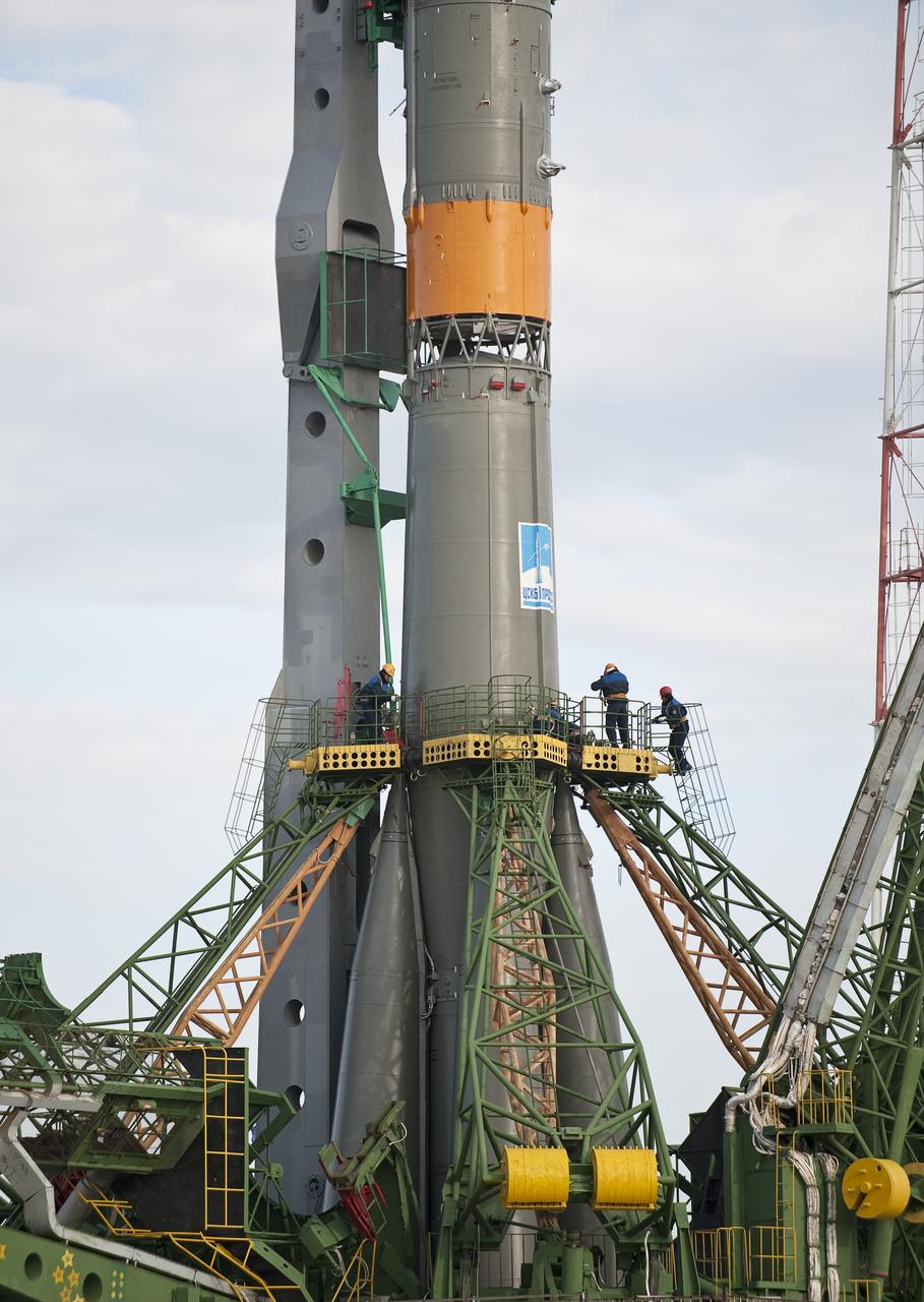 Pad technicians secure the Soyuz TMA-18 spacecraft shortly after it was rolled out by train to the launch pad at the Baikonur Cosmodrome, Kazakhstan, Wednesday, March, 31, 2010. The launch of the Soyuz spacecraft with Expedition 23 Soyuz Commander Alexander Skvortsov of Russia, Flight Engineer Mikhail Kornienko of Russia, and NASA Flight Engineer Tracy Caldwell Dyson is scheduled for Friday, April 2, 2010 at 10:04 a.m. Kazakhstan time. Photo Credit (NASA/Bill Ingalls)