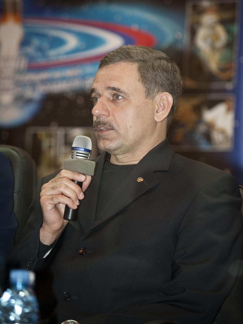 Expedition 23 Flight Engineer Mikhail Kornienko says a few words during the State Commission meeting to approve the Soyuz launch of Kornienko, Expedition 23 Soyuz Commander Alexander Skvortsov and Expedition 23 Flight Engineer Tracy Caldwell Dyson on Thursday, April 1, 2010 in Baikonur, Kazakhstan. The crew is kept in a separate room with a glass window in order to help maintain their health.  Photo Credit: (NASA/Bill Ingalls)