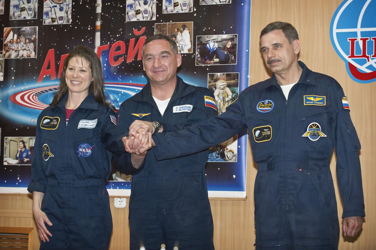 Expedition 23 crew members, from left, NASA’s Tracy Caldwell Dyson, Russian Alexander Skvortsov and Russian Mikhail Kornienko pose for photographers during a press conference held at the Cosmonaut Hotel in Baikonur, Kazakhstan, Thursday, April 1, 2010. The launch of the Soyuz spacecraft with Expedition 23 NASA Flight Engineer Tracy Caldwell Dyson, Soyuz Commander Alexander Skvortsov and Flight Engineer Mikhail Kornienko is scheduled for Friday, April 2, 2010 at 10:04 a.m. Kazakhstan time.  Photo Credit: (NASA/Bill Ingalls)