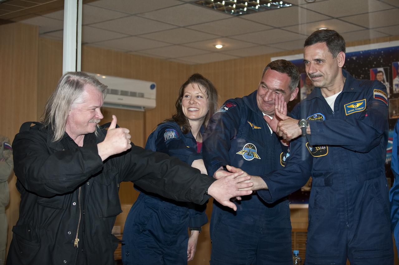 Expedition 23 crew members NASA’s Tracy Caldwell Dyson (second from left), Russian Alexander Skvortsov and Russian Mikhail Kornienko (right) pose for photographers during a press conference held at the Cosmonaut Hotel in Baikonur, Kazakhstan, Thursday, April 1, 2010. The launch of the Soyuz spacecraft with Expedition 23 NASA Flight Engineer Tracy Caldwell Dyson, Soyuz Commander Alexander Skvortsov and Flight Engineer Mikhail Kornienko is scheduled for Friday, April 2, 2010 at 10:04 a.m. Kazakhstan time.  Photo Credit: (NASA/Bill Ingalls)
