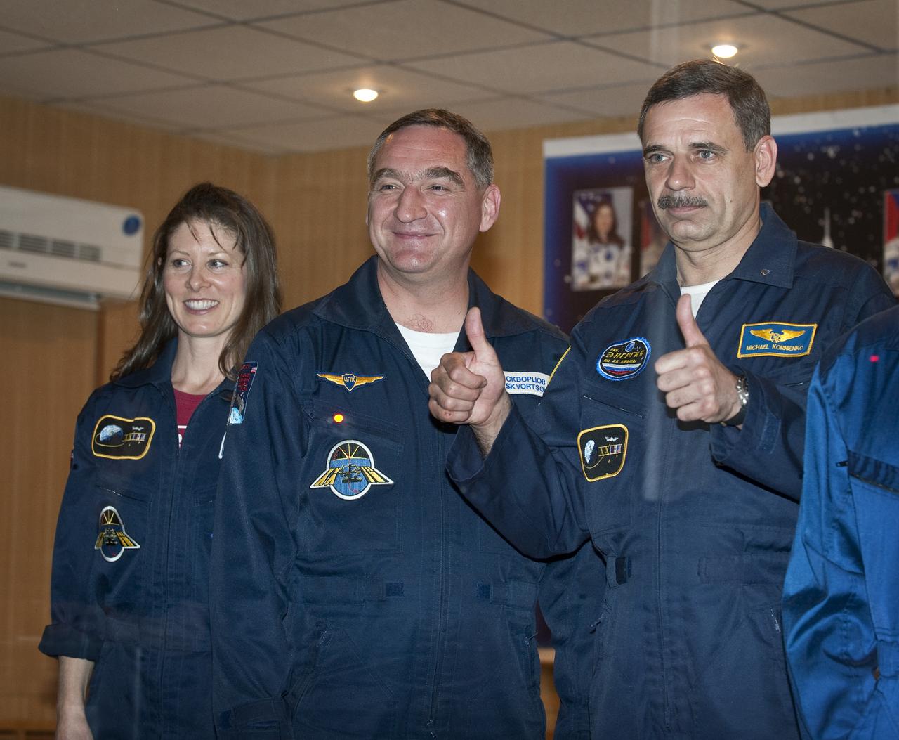 Expedition 23 crew members, from left, NASA’s Tracy Caldwell Dyson, Russian Alexander Skvortsov and Russian Mikhail Kornienko pose for photographers during a press conference held at the Cosmonaut Hotel in Baikonur, Kazakhstan, Thursday, April 1, 2010. The launch of the Soyuz spacecraft with Expedition 23 NASA Flight Engineer Tracy Caldwell Dyson, Soyuz Commander Alexander Skvortsov and Flight Engineer Mikhail Kornienko is scheduled for Friday, April 2, 2010 at 10:04 a.m. Kazakhstan time.  Photo Credit: (NASA/Bill Ingalls)