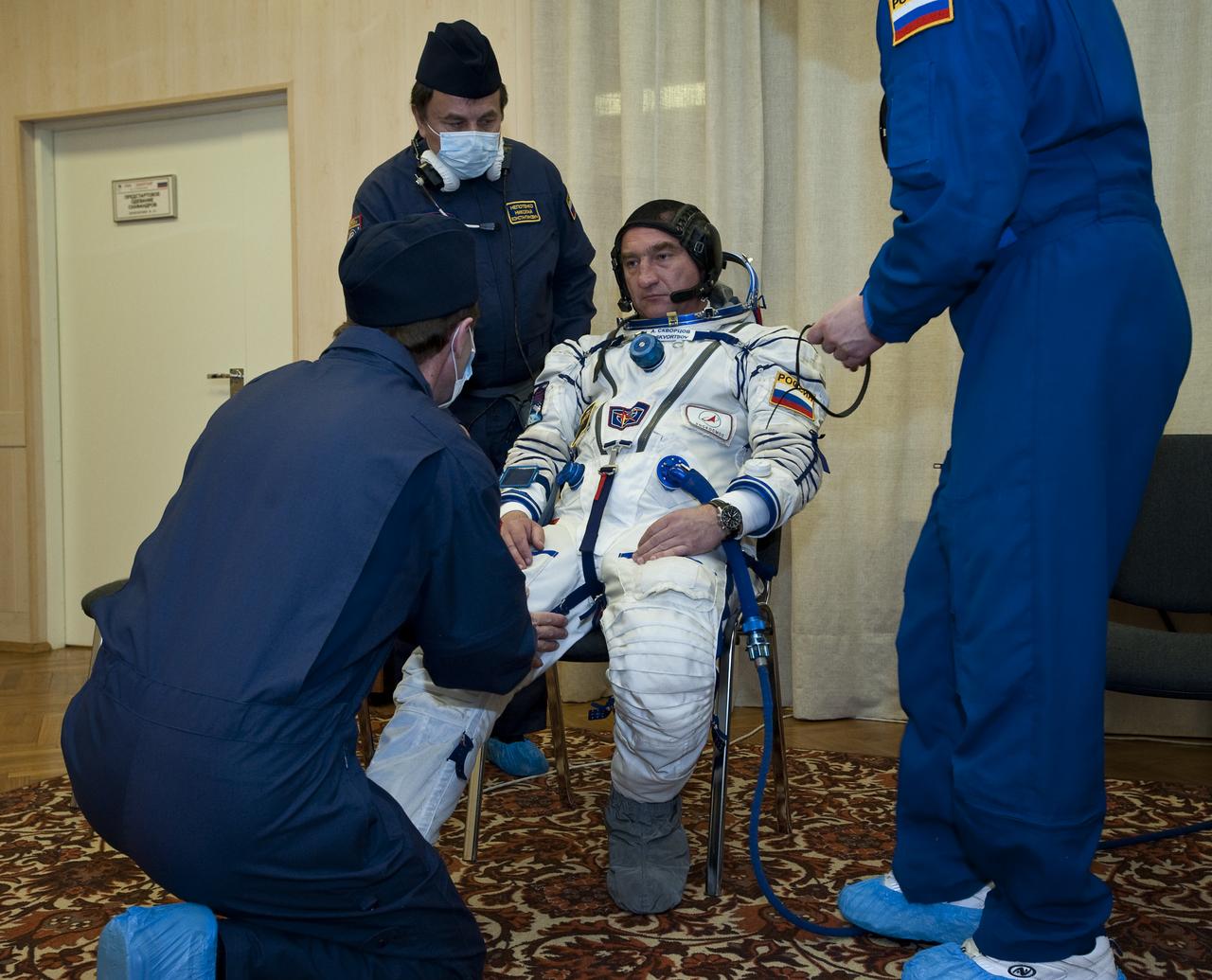 Expedition 23 Soyuz Commander Alexander Skvortsov has his Russian Sokol suit prepared for launch by a technician at the Baikonur Cosmodrome in Baikonur, Kazakhstan, Friday, April 2, 2010. Skvortsov and fellow Expedition 23 crewmembers Flight Engineer Mikhail Kornienko of the Russia and NASA Flight Engineer Tracy Caldwell Dyson of the U.S. launched in their Soyuz TMA-18 rocket from the Baikonur Cosmodrome in Kazakhstan on Friday, April 2, 2010. Photo Credit: (NASA/Carla Cioffi)