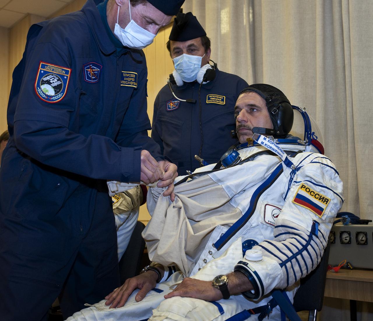 Expedition 23 Flight Engineer Mikhail Kornienko of the Russia has his Russian Sokol suit prepared for launch by a technician at the Baikonur Cosmodrome in Baikonur, Kazakhstan, Friday, April 2, 2010. Kornienko and fellow Expedition 23 crewmembers Soyuz Commander Alexander Skvortsov and NASA Flight Engineer Tracy Caldwell Dyson of the U.S. launched in their Soyuz TMA-18 rocket from the Baikonur Cosmodrome in Kazakhstan on Friday, April 2, 2010. Photo Credit: (NASA/Carla Cioffi)