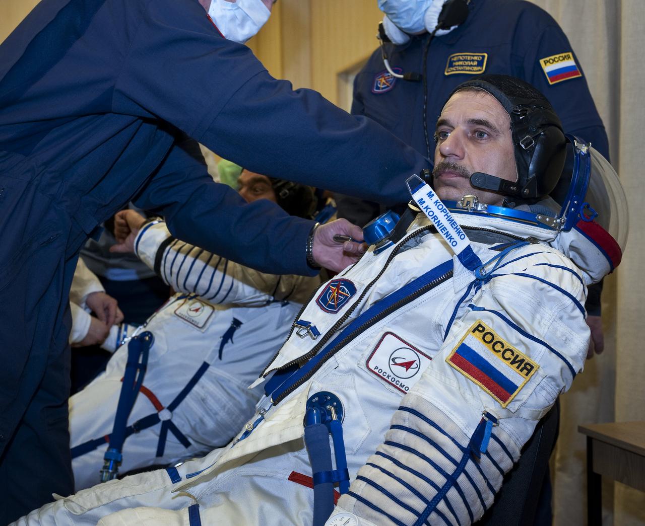 Expedition 23 Flight Engineer Mikhail Kornienko of the Russia has his Russian Sokol suit prepared for launch by a technician at the Baikonur Cosmodrome in Baikonur, Kazakhstan, Friday, April 2, 2010. Kornienko and fellow Expedition 23 crewmembers Soyuz Commander Alexander Skvortsov and NASA Flight Engineer Tracy Caldwell Dyson of the U.S. launched in their Soyuz TMA-18 rocket from the Baikonur Cosmodrome in Kazakhstan on Friday, April 2, 2010. Photo Credit: (NASA/Carla Cioffi)