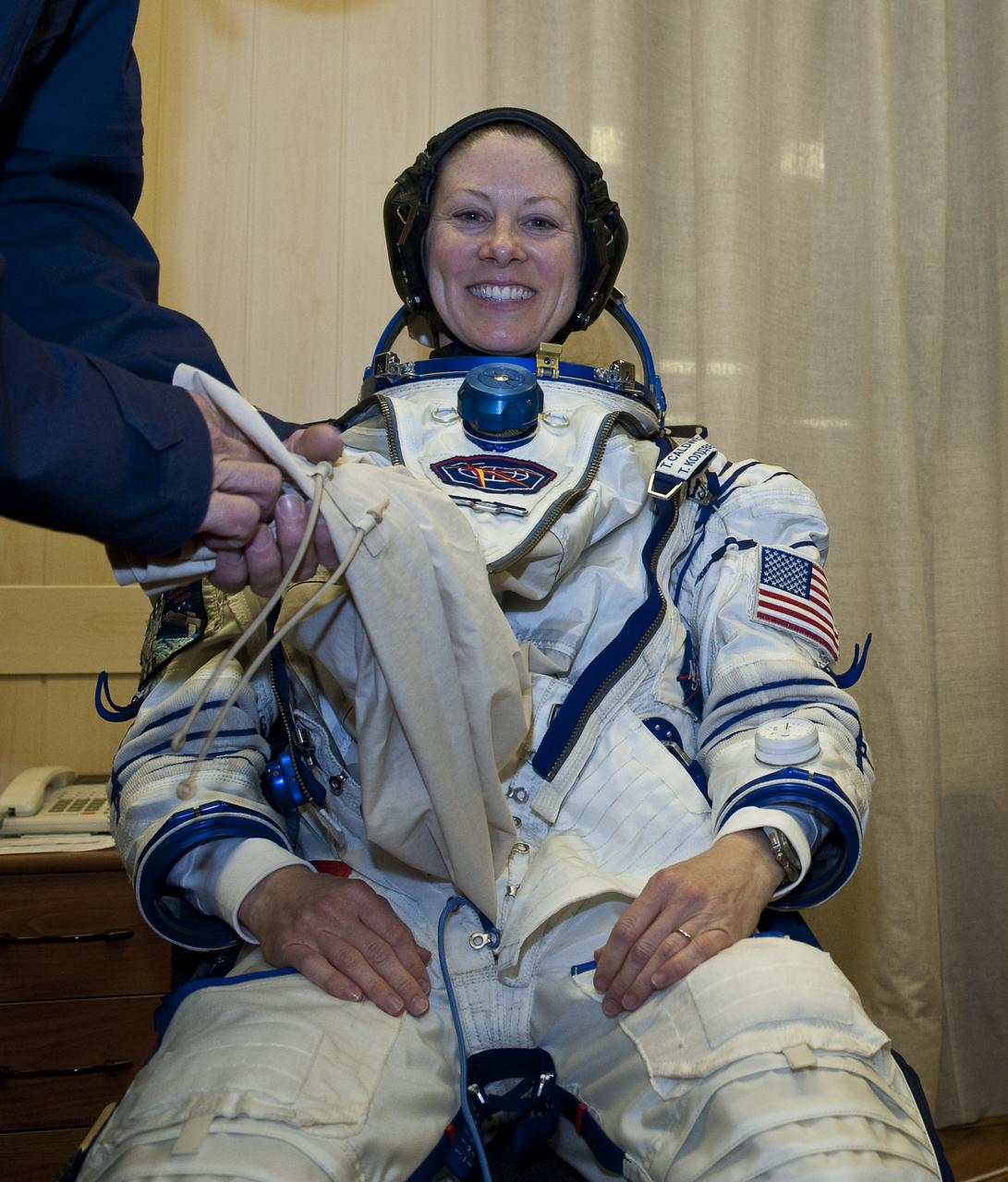 Expedition 23 NASA Flight Engineer Tracy Caldwell Dyson of the U.S. has her Russian Sokol suit prepared for launch by a technician at the Baikonur Cosmodrome in Baikonur, Kazakhstan, Friday, April 2, 2010. Caldwell Dyson and fellow Expedition 23 crew members Soyuz Commander Alexander Skvortsov and Flight Engineer Mikhail Kornienko of Russia launched in their Soyuz TMA-18 rocket from the Baikonur Cosmodrome in Kazakhstan on Friday, April 2, 2010. Photo Credit: (NASA/Carla Cioffi)