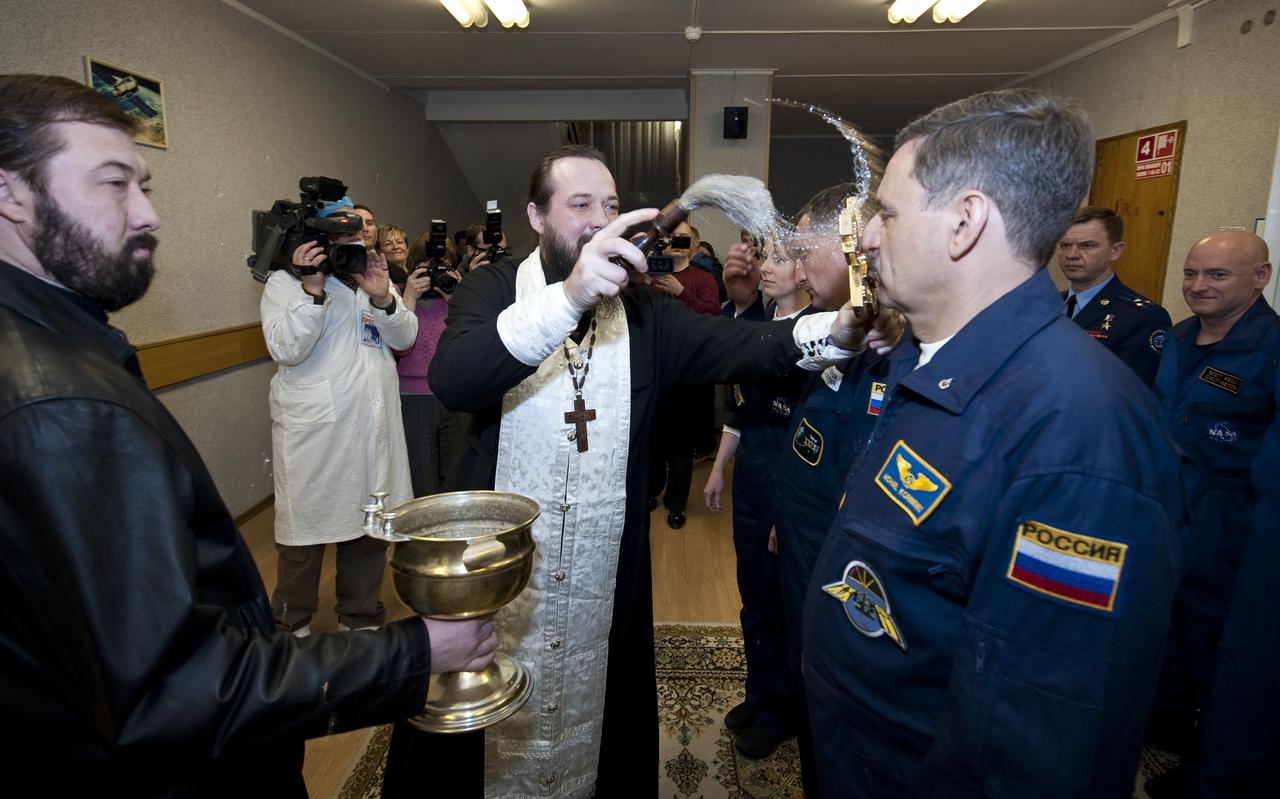 Expedition 23 Flight Engineer Russian cosmonaut Mikhail Kornienko, right, receives the traditional blessing from a Russian Orthodox priest at the Cosmonaut Hotel on the morning of the launch of Expedition 23 on a Soyuz rocket to the International Space Station, Friday, April 2, 2010 in Baikonur, Kazakhstan. Photo Credit: (NASA/Bill Ingalls) 