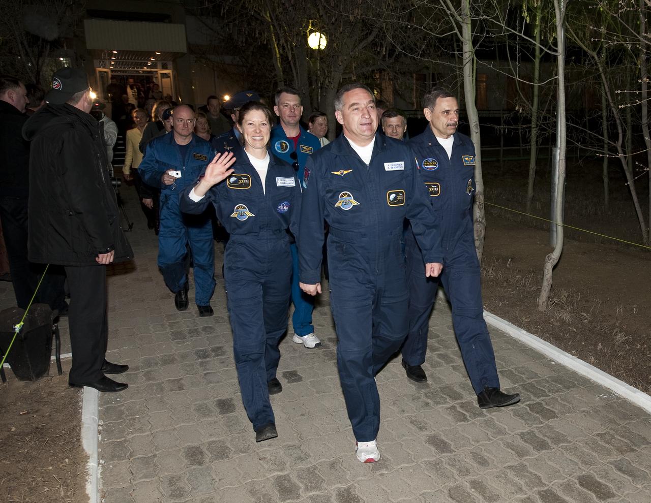 Expedition 23 crew members NASA Flight Engineer Tracy Caldwell Dyson, left, Soyuz Commander Alexander Skvortsov and Flight Engineer Mikhail Kornienko, right, leave the Cosmonaut Hotel on the morning of their launch on a Soyuz rocket to the International Space Station, Friday, April 2, 2010, in Baikonur, Kazakhstan.  Photo Credit:  (NASA/Bill Ingalls)