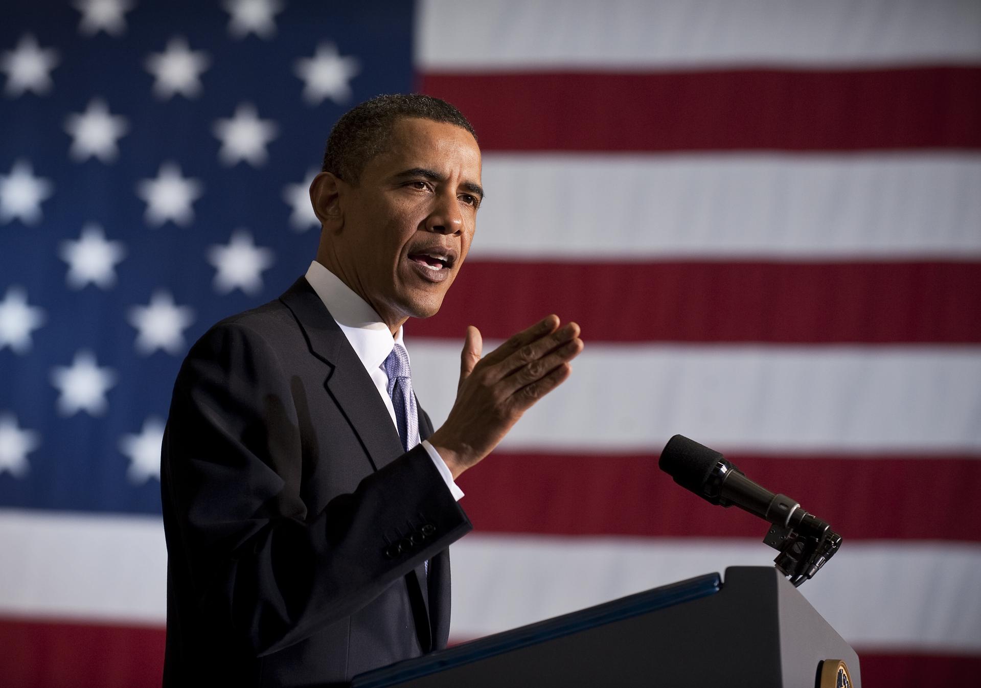President Obama speaks in front of an American flag