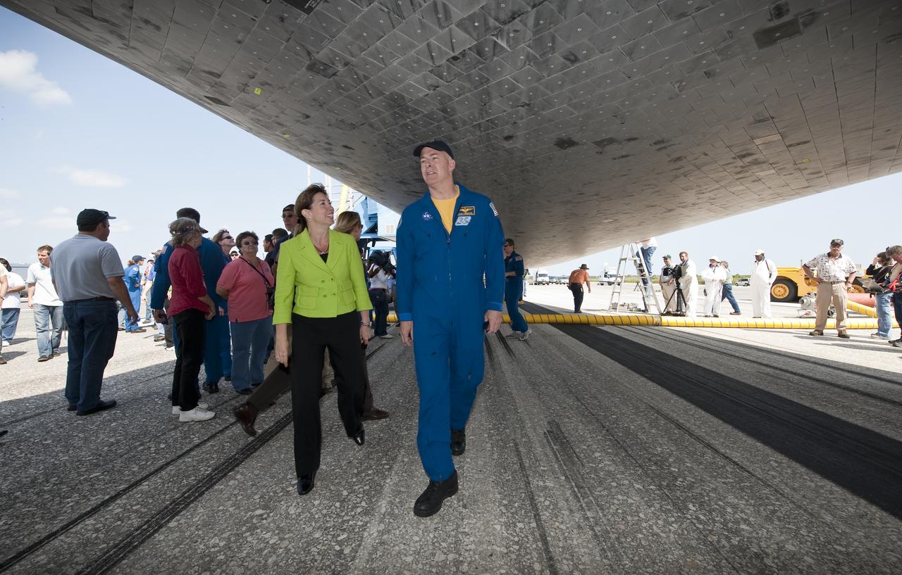 NASA Deputy Administrator Lori Garver and STS-131 Commander Alan G. Poindexter walk around under the space shuttle Discovery shortly after Discovery and the STS-131 crew landed at the Kennedy Space Center in Cape Canaveral, Fla., Tuesday, April 20, 2010. STS-131 mission crew, Commander Alan G. Poindexter, Pilot James P. Dutton Jr. and Mission Specialists Dorothy Metcalf-Lindenburger, Rick Mastracchio, Stephanie Wilson, Clayton Anderson and Japanese astronaut Naoko Yamazaki returned from their 14-day journey of more than 6.2 million miles.  The STS-131 mission to the International Space Station delivered science racks, new crew sleeping quarters, equipment and supplies. Photo credit: (NASA/Bill Ingalls)