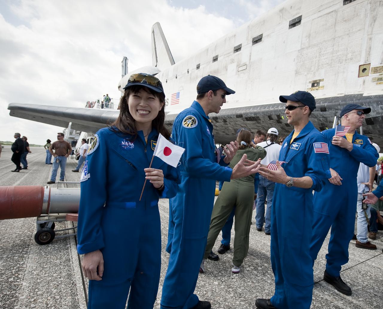 Japanese astronaut Naoko Yamazaki, holds a Japanese flag near the space shuttle Discovery shortly after Discovery and the STS-131 crew landed at the Kennedy Space Center in Cape Canaveral, Fla., Tuesday, April 20, 2010. STS-131 mission crew, Commander Alan G. Poindexter, Pilot James P. Dutton Jr. and Mission Specialists Dorothy Metcalf-Lindenburger, Rick Mastracchio, Stephanie Wilson, Clayton Anderson and Japanese astronaut Naoko Yamazaki returned from their 14-day journey of more than 6.2 million miles. The STS-131 mission to the International Space Station delivered science racks, new crew sleeping quarters, equipment and supplies. Photo credit: (NASA/Bill Ingalls)