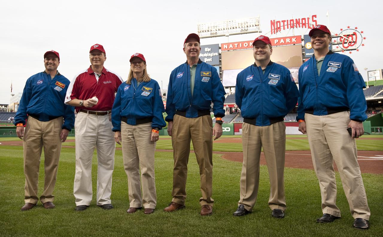 NASA STS-130 crew Commander George Zamka, far left, Pilot Terry Virts, Mission Specialists Kathryn Hire, Stephen Robinson, Nicholas Patrick and Robert Behnken, far right, pose for pictures on the field at Nationals Park, Tuesday, April 20, 2010, in Washington.  Photo Credit:  (NASA/Carla Cioffi)
