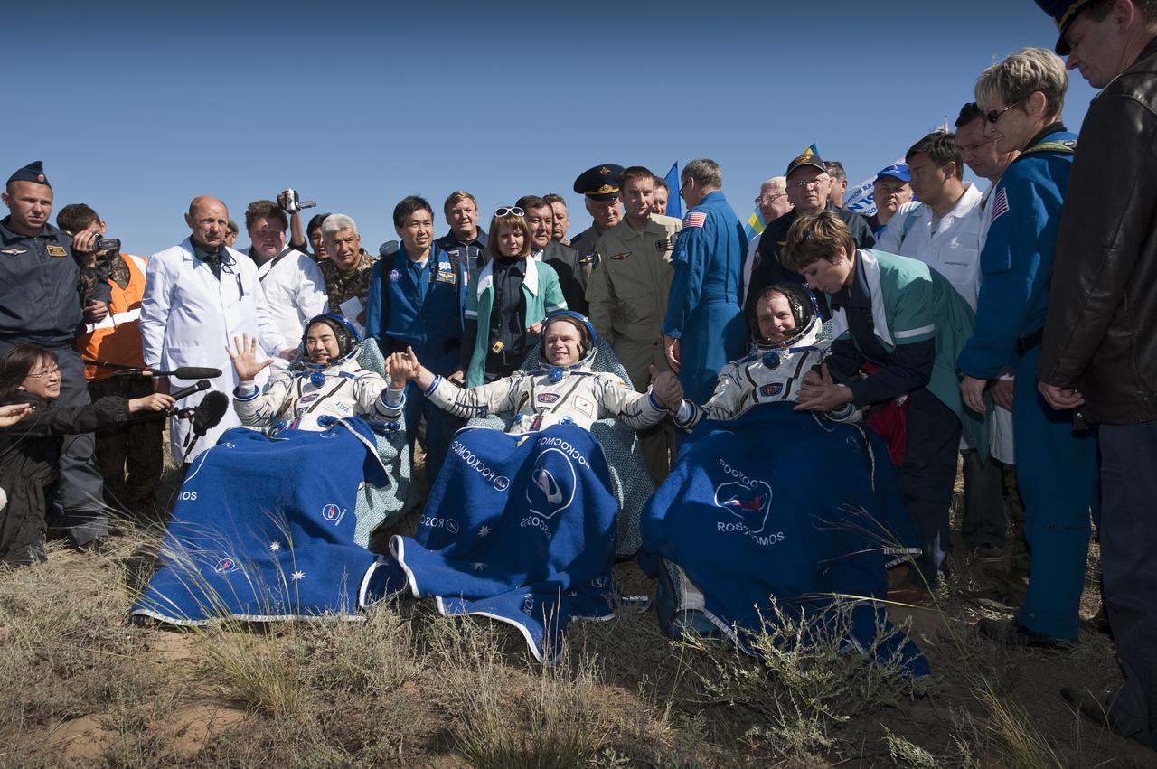 Expedition 23 Flight Engineer Soichi Noguchi, left, Commander Oleg Kotov, center, and Flight Engineer T.J. Creamer sit in chairs outside the Soyuz Capsule just minutes after they landed near the town of Zhezkazgan, Kazakhstan on Wednesday, June 2, 2010. NASA Astronaut Creamer, Russian Cosmonaut Kotov and Japanese Astronaut Noguchi are returning from six months onboard the International Space Station where they served as members of the Expedition 22 and 23 crews. Photo Credit: (NASA/Bill Ingalls)