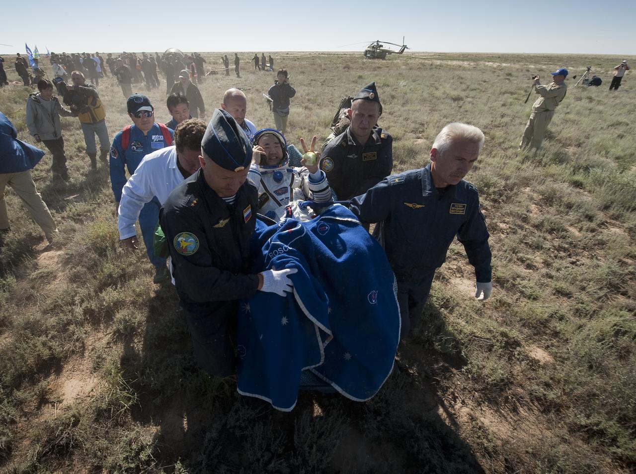 Expedition 23 Flight Engineer Soichi Noguchi is carried in a chair to the medical tent just minutes after he and fellow crew members T.J. Creamer and Commander Oleg Kotov landed in their Soyuz TMA-17 capsule near the town of Zhezkazgan, Kazakhstan on Wednesday, June 2, 2010. NASA Astronaut Creamer, Russian Cosmonaut Kotov and Japanese Astronaut Noguchi are returning from six months onboard the International Space Station where they served as members of the Expedition 22 and 23 crews. Photo Credit: (NASA/Bill Ingalls)