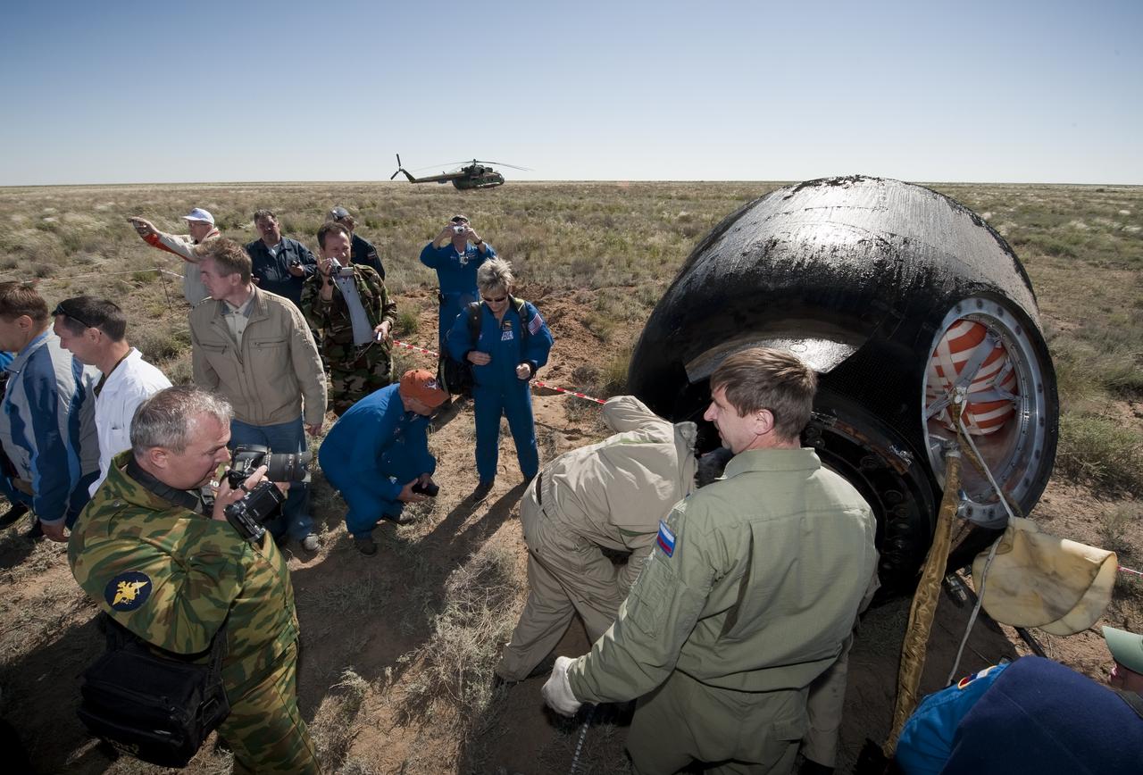 U.S. and Russian support personnel work around the Soyuz TMA-17 spacecraft after it landed with Expedition 23 Commander Oleg Kotov and Flight Engineers T.J. Creamer and Soichi Noguchi near the town of Zhezkazgan, Kazakhstan on Wednesday, June 2, 2010. NASA Astronaut Creamer, Russian Cosmonaut Kotov and Japanese Astronaut Noguchi are returning from six months onboard the International Space Station where they served as members of the Expedition 22 and 23 crews. Photo Credit: (NASA/Bill Ingalls)