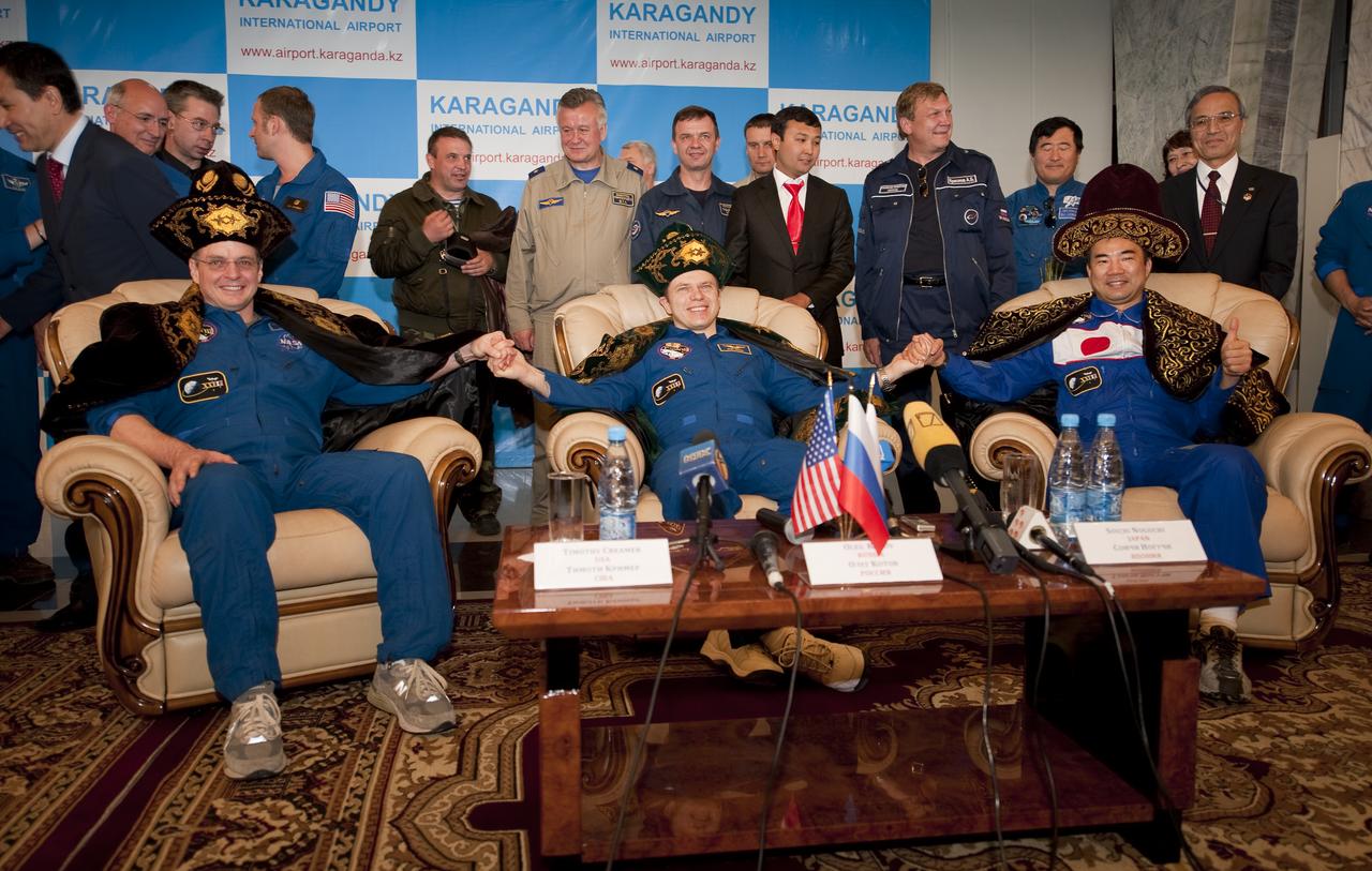 Expedition 23 Flight Engineer T.J. Creamer, left, Commander Oleg Kotov, center, and Flight Engineer Soichi Noguchi wear ceremonial Kazakhstan hats and robes presented to them during a welcome home ceremony held at the Karaganda airport in Karaganda, Kazakhstan on Wednesday, June 2, 2010.  NASA Astronaut Creamer, Russian Cosmonaut Kotov and Japanese Astronaut Noguchi landed their Soyuz TMA-17 Capsule near the town of Zhezkazgan, Kazakhstan and returned from six months onboard the International Space Station where they served as members of the Expedition 22 and 23 crews. Photo Credit: (NASA/Bill Ingalls)
