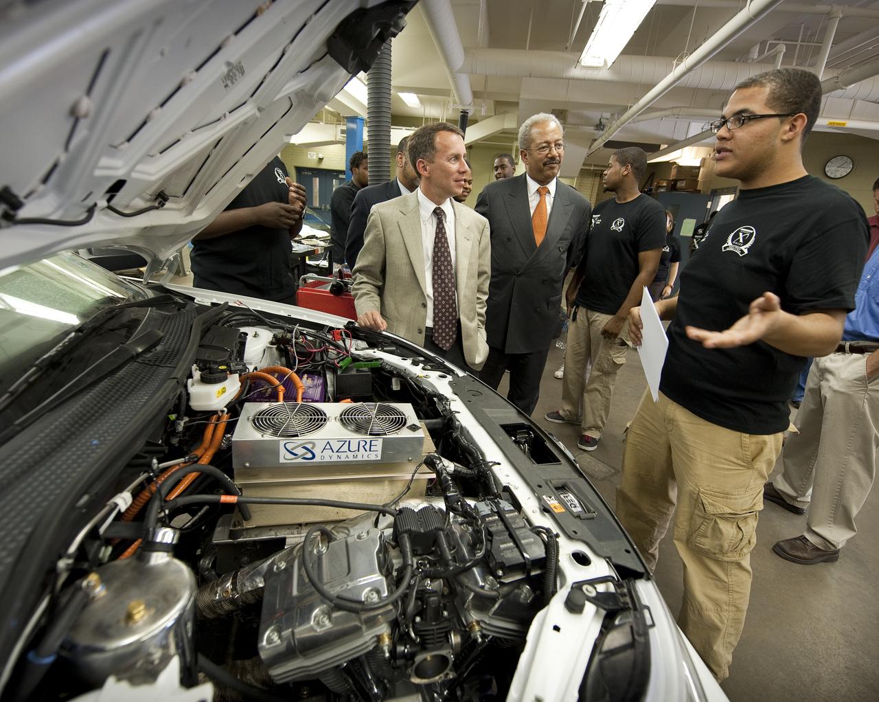 NASA Chief Technologist Bobby Braun, left, and Congressman Chaka Fattah (D-PA), center, listen to Azeem Hill, a member of the West Philly Hybrid X Team at West Philadelphia High School in Philadelphia, Monday, June 7, 2010.  The prize-winning West Philly Hybrid X Team has drawn international recognition as the only high school among 22 finalists in the Progressive Insurance Automotive X Prize (PIAXP) competition to develop cars that achieve over 100 MPG.  Photo Credit: (NASA/Bill Ingalls)