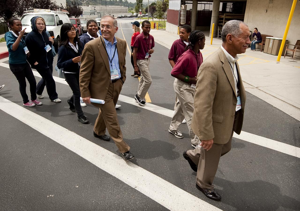 Jet Propulsion Laboratory Director Dr. Charles Elachi, center, and NASA Administrator Charles Bolden, right, lead school students to High Bay One at JPL during the kick off of NASA's Summer of Innovation program at the Jet Propulsion Laboratory in Pasadena, Calif., Thursday, June 10, 2010. Through the program, NASA will engage thousands of middle school students and teachers in stimulating math and science-based education programs with the goal of increasing the number of future scientists, mathematicians, and engineers.  Photo Credit: (NASA/Bill Ingalls)