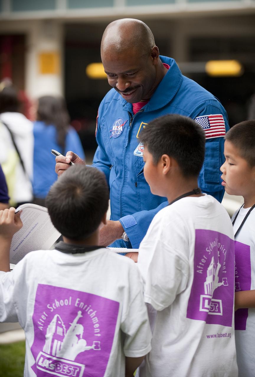 NASA astronaut Leland Melvin signs autographs to middle school students during the kick off of NASA's Summer of Innovation program at the Jet Propulsion Laboratory in Pasadena, Calif., Thursday, June 10, 2010. Through the program, NASA will engage thousands of middle school students and teachers in stimulating math and science-based education programs with the goal of increasing the number of future scientists, mathematicians, and engineers.  Photo Credit: (NASA/Bill Ingalls)